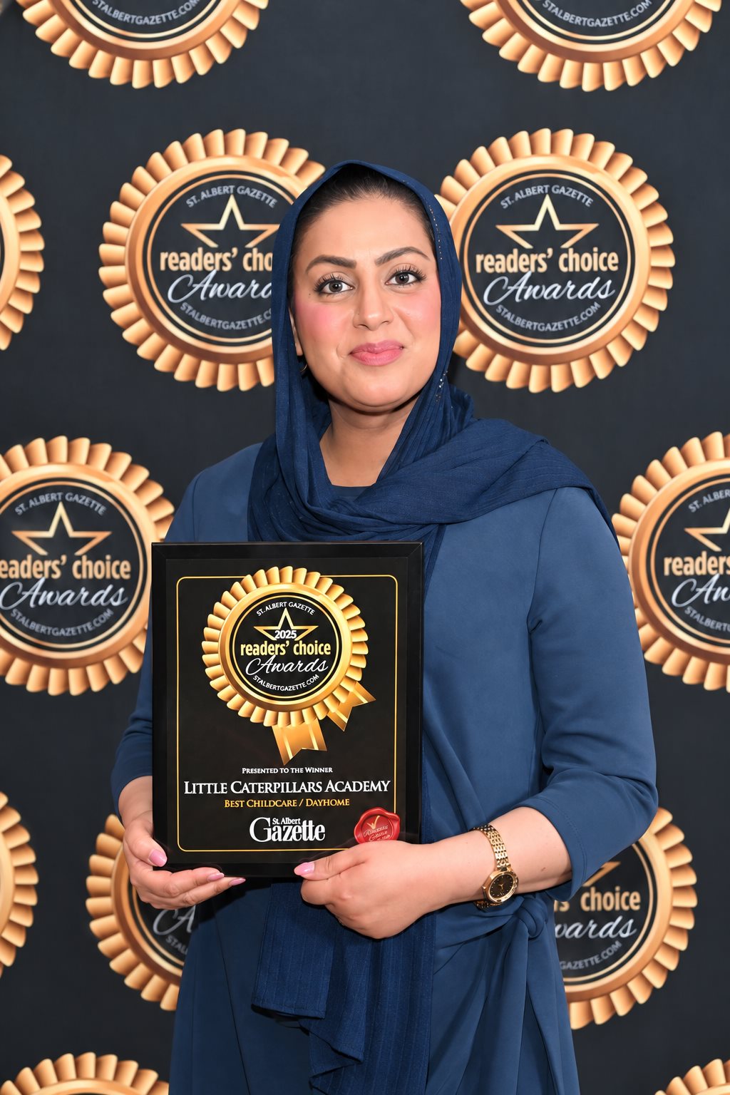 Fatima holding the academy’s 2025 St. Albert Gazette Readers’ Choice award